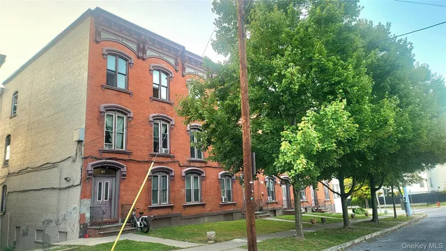 a front view of a residential apartment building with a yard