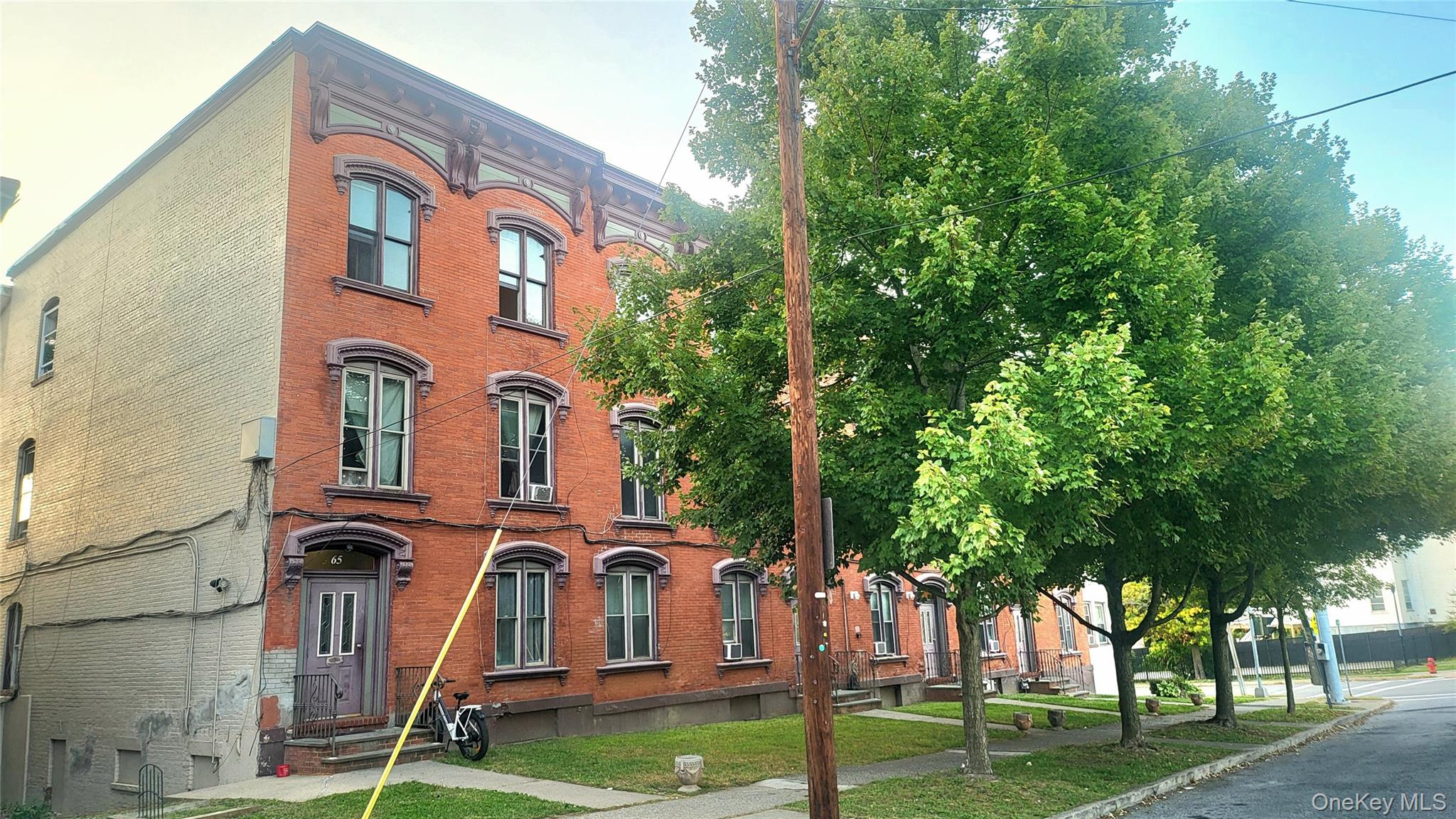 a front view of a residential apartment building with a yard