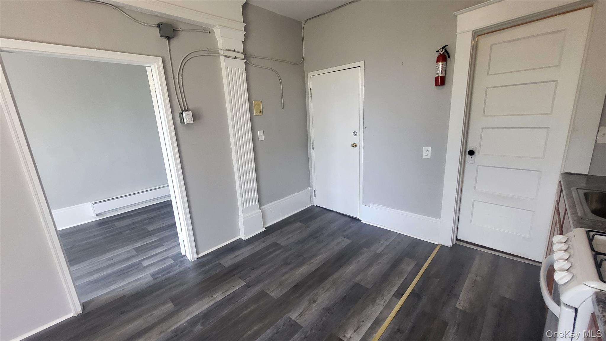 65 South Hamilton Street, Unit 9 Poughkeepsie, NY 12601 - Photo 11 of 20 a view of a hallway with wooden floor and staircase