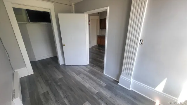an entryway with wooden floor and a hallway