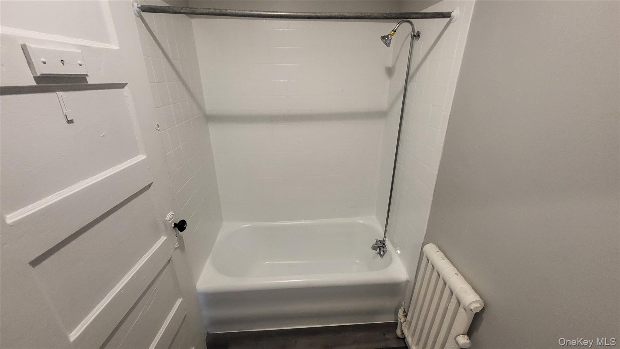 65 South Hamilton Street, Unit 9 Poughkeepsie, NY 12601 - Photo 17 of 20 a bathroom with a bathtub and a shower