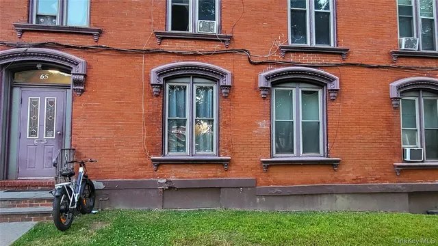 front view of brick house with a large windows