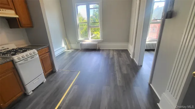 a view of a kitchen from a hallway