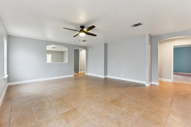 a view of a livingroom with a ceiling fan and window