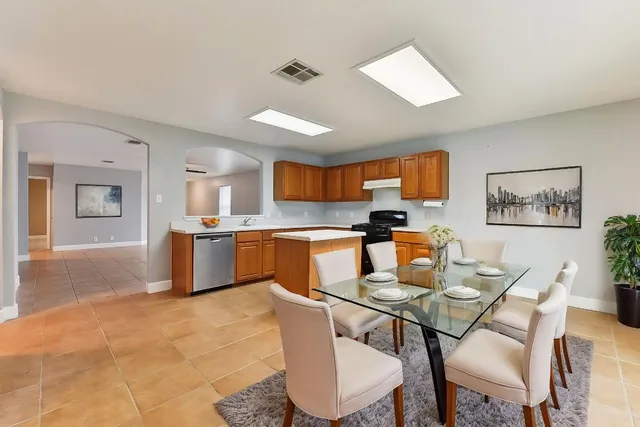 a view of a dining room with furniture and a kitchen