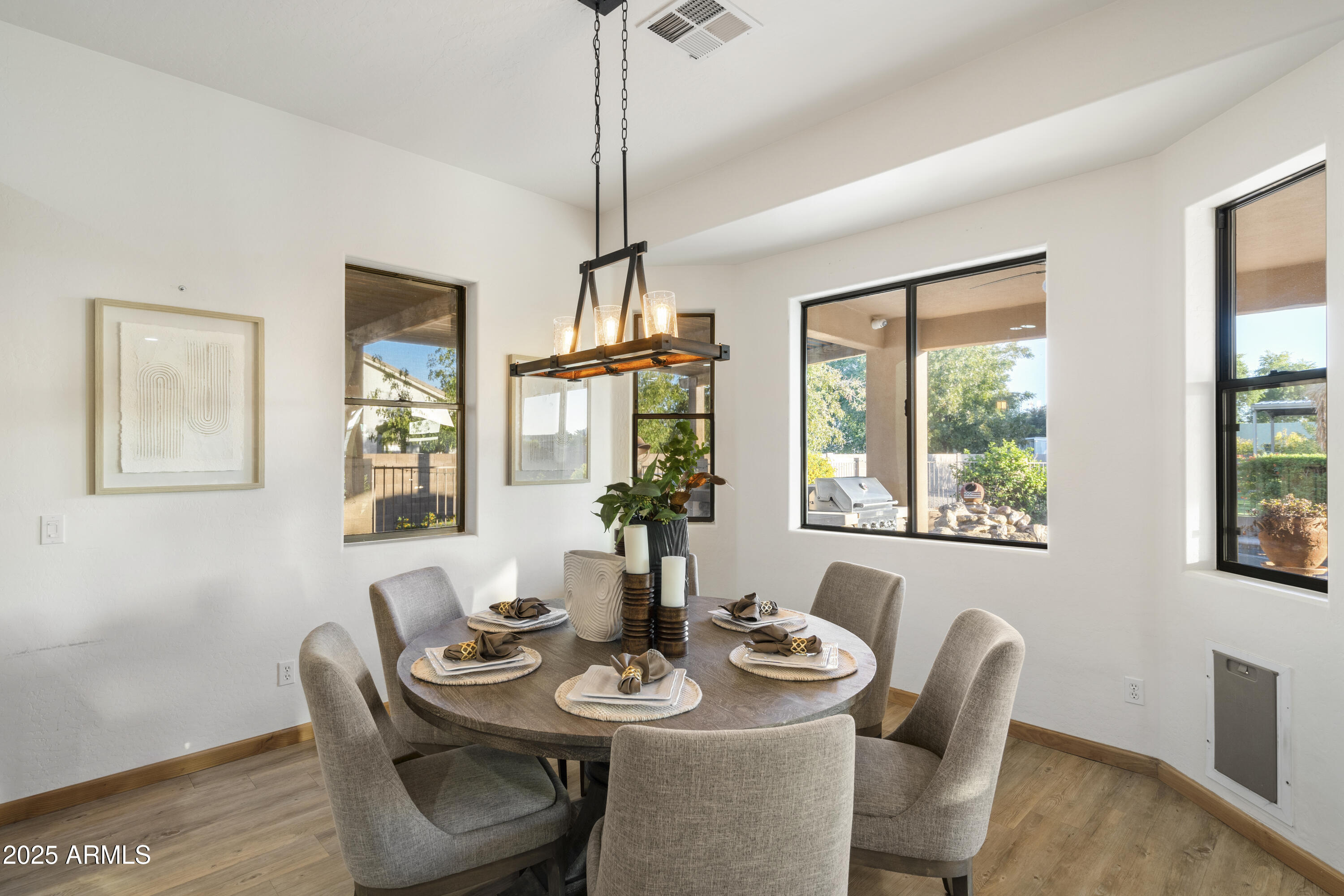 2667 East Melrose Street Gilbert, AZ 85297 - Photo 11 of 32 a view of a dining room with furniture window and wooden floor