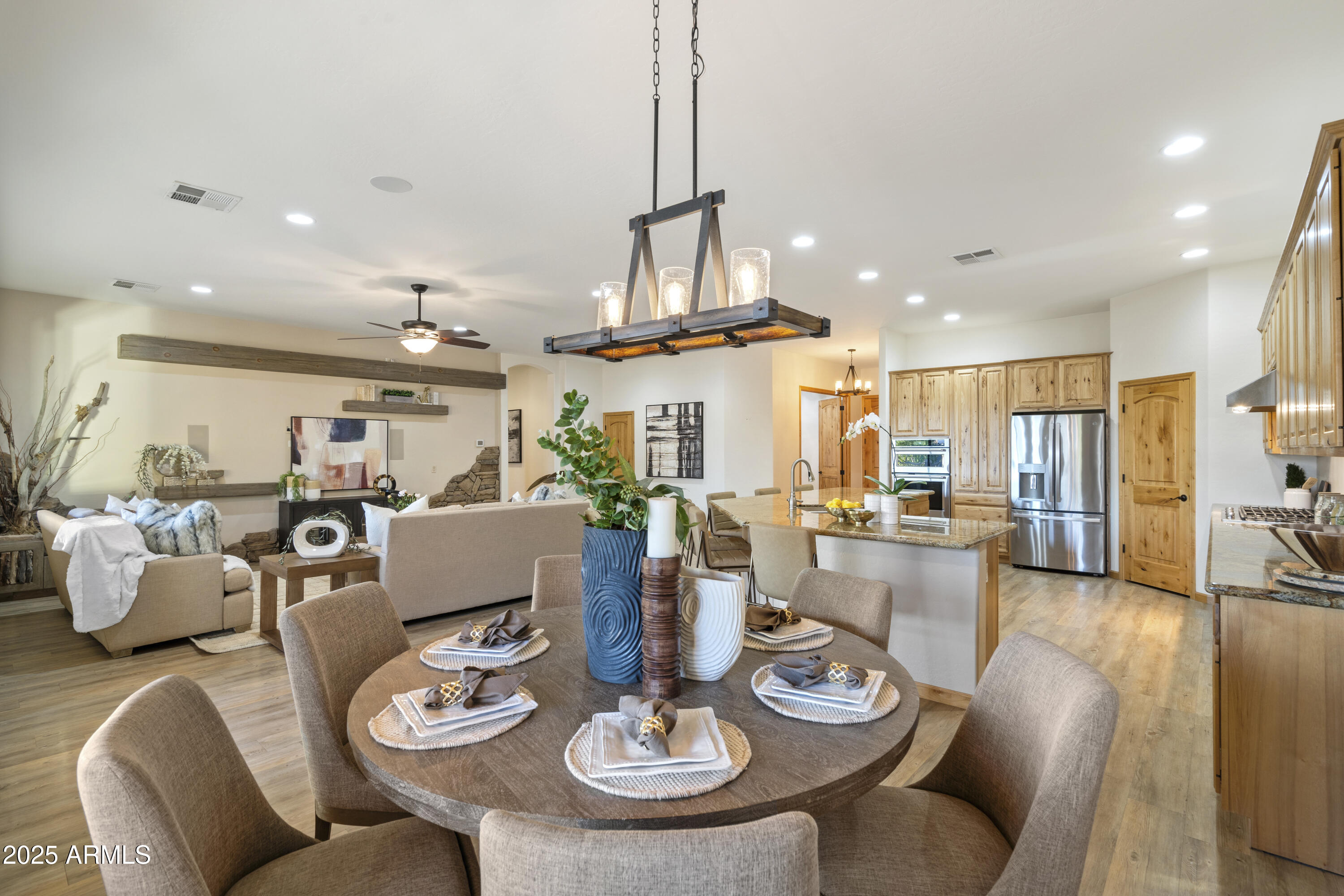 2667 East Melrose Street Gilbert, AZ 85297 - Photo 12 of 32 a living room with furniture kitchen view and a chandelier