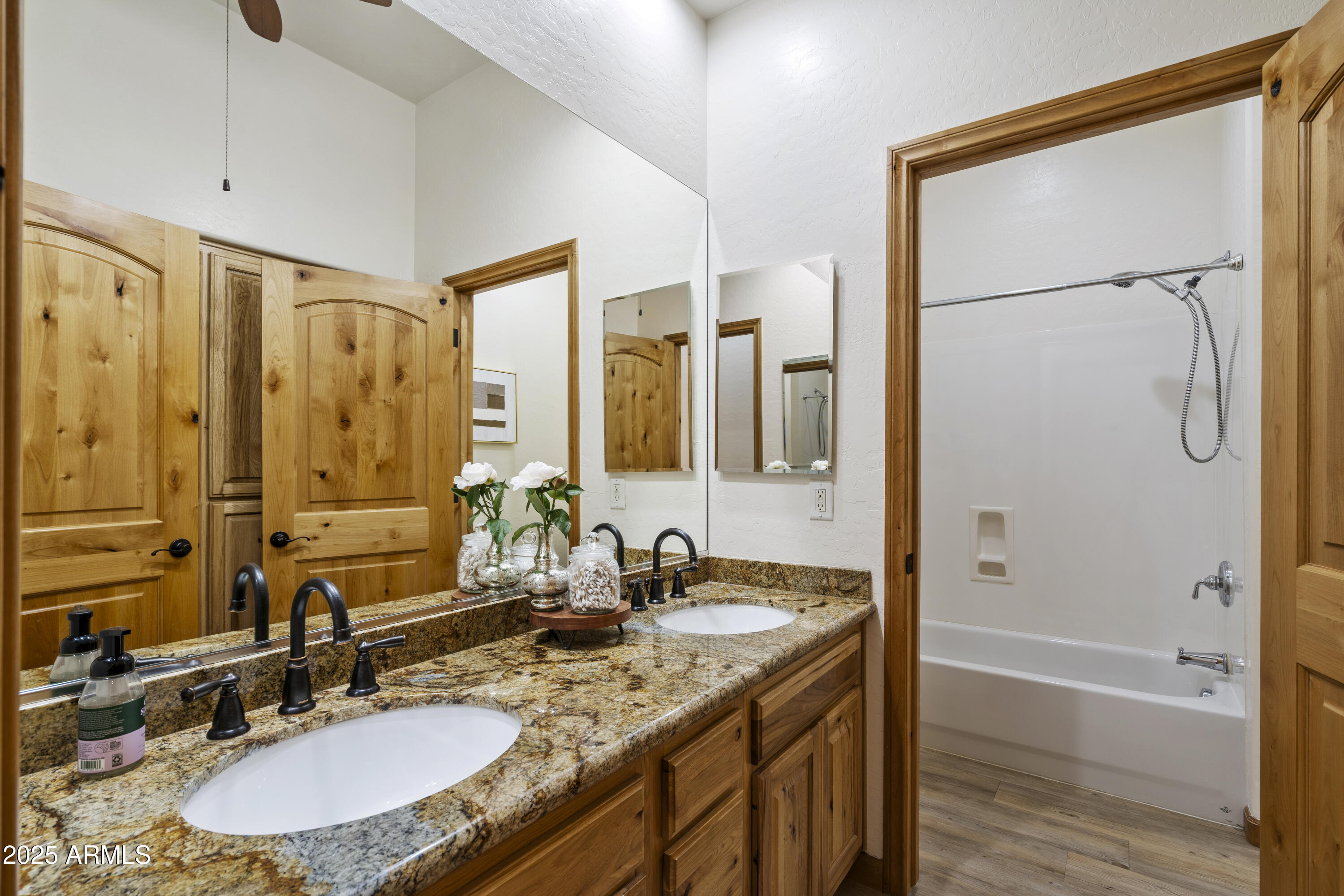 2667 East Melrose Street Gilbert, AZ 85297 - Photo 20 of 32 a bathroom with a granite countertop sink a mirror a shower and a bathtub