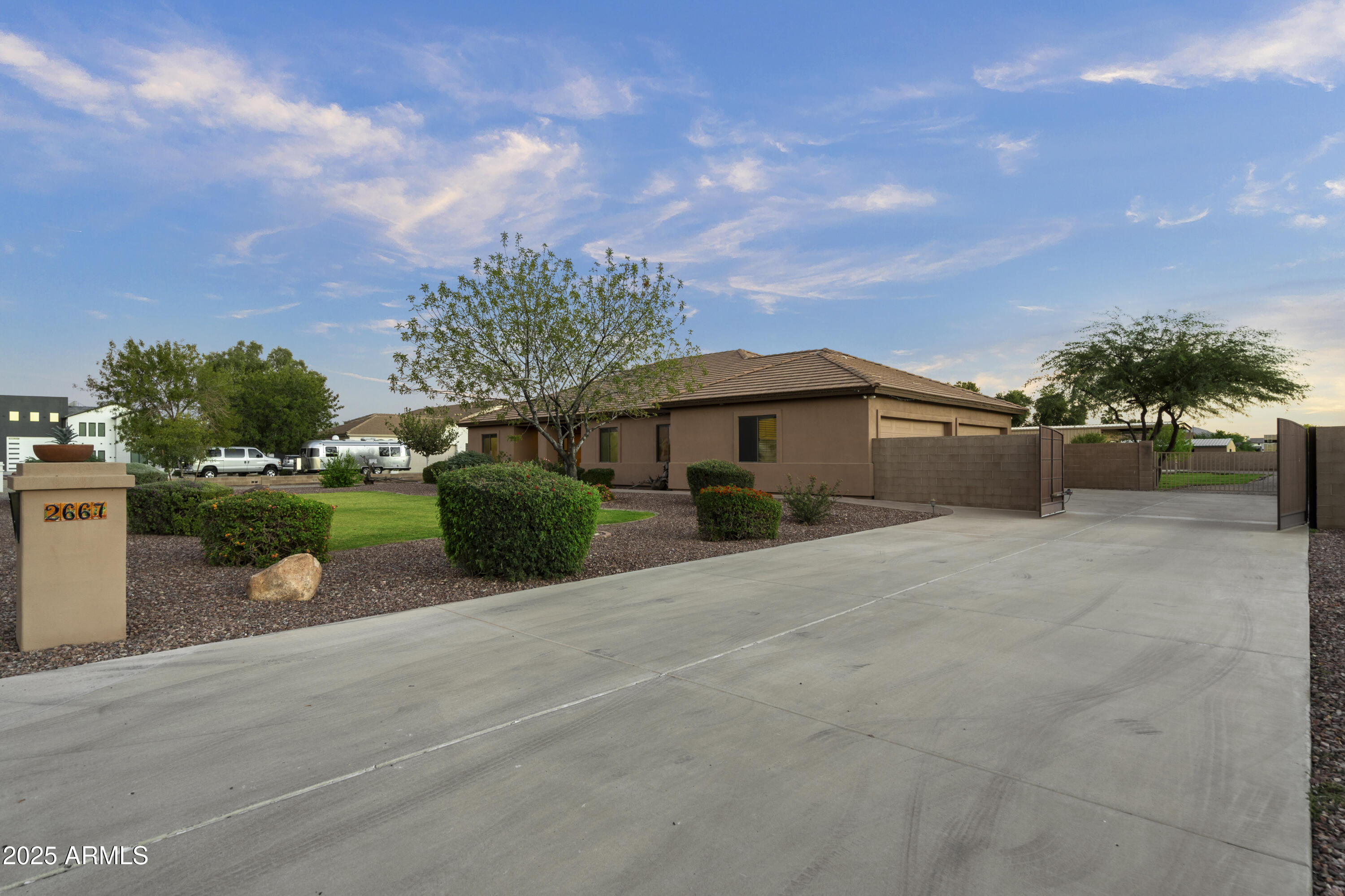 2667 East Melrose Street Gilbert, AZ 85297 - Photo 28 of 32 a front view of a house with a yard and garage