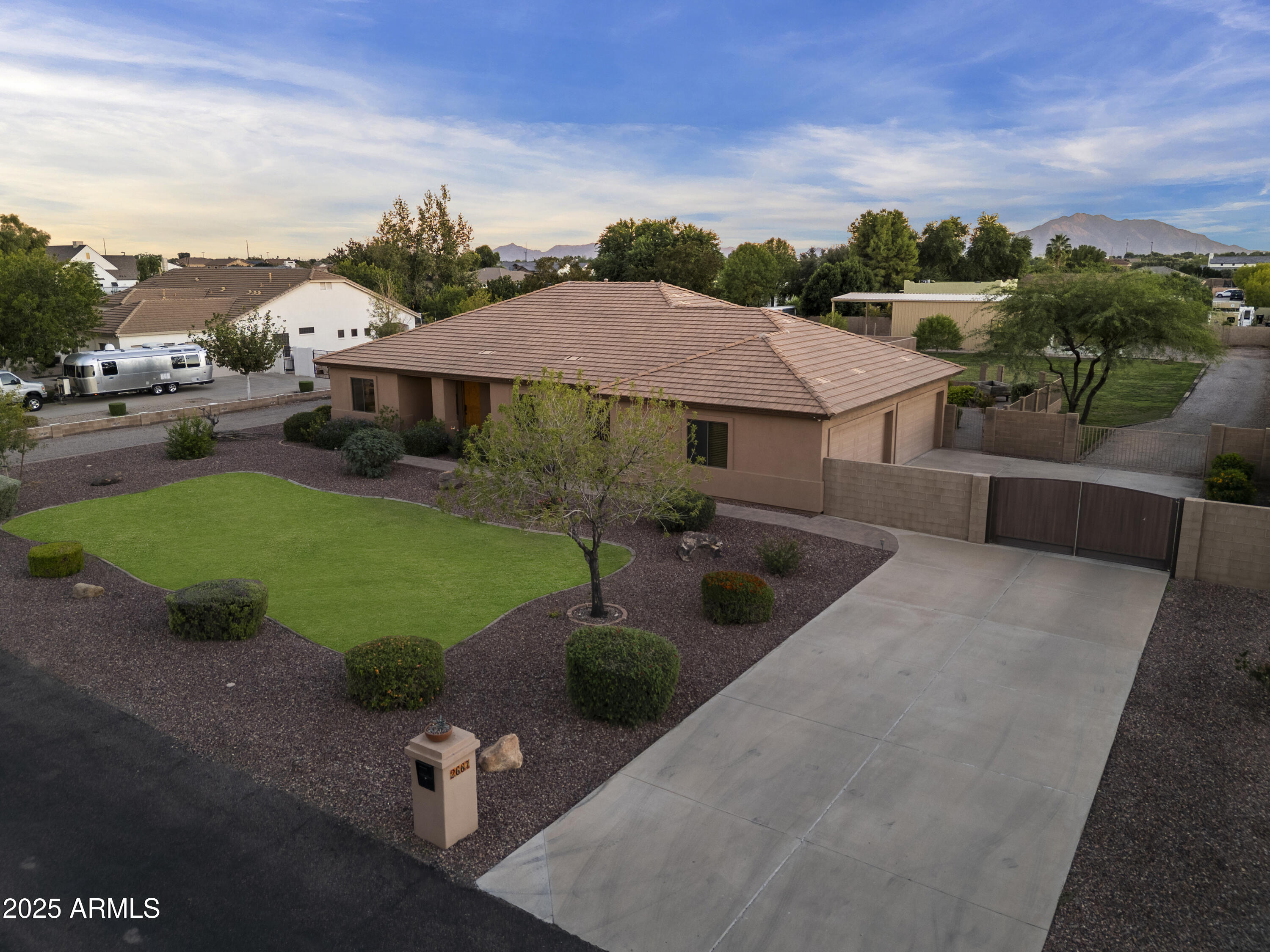 2667 East Melrose Street Gilbert, AZ 85297 - Photo 3 of 32 an aerial view of a house with garden space and street view