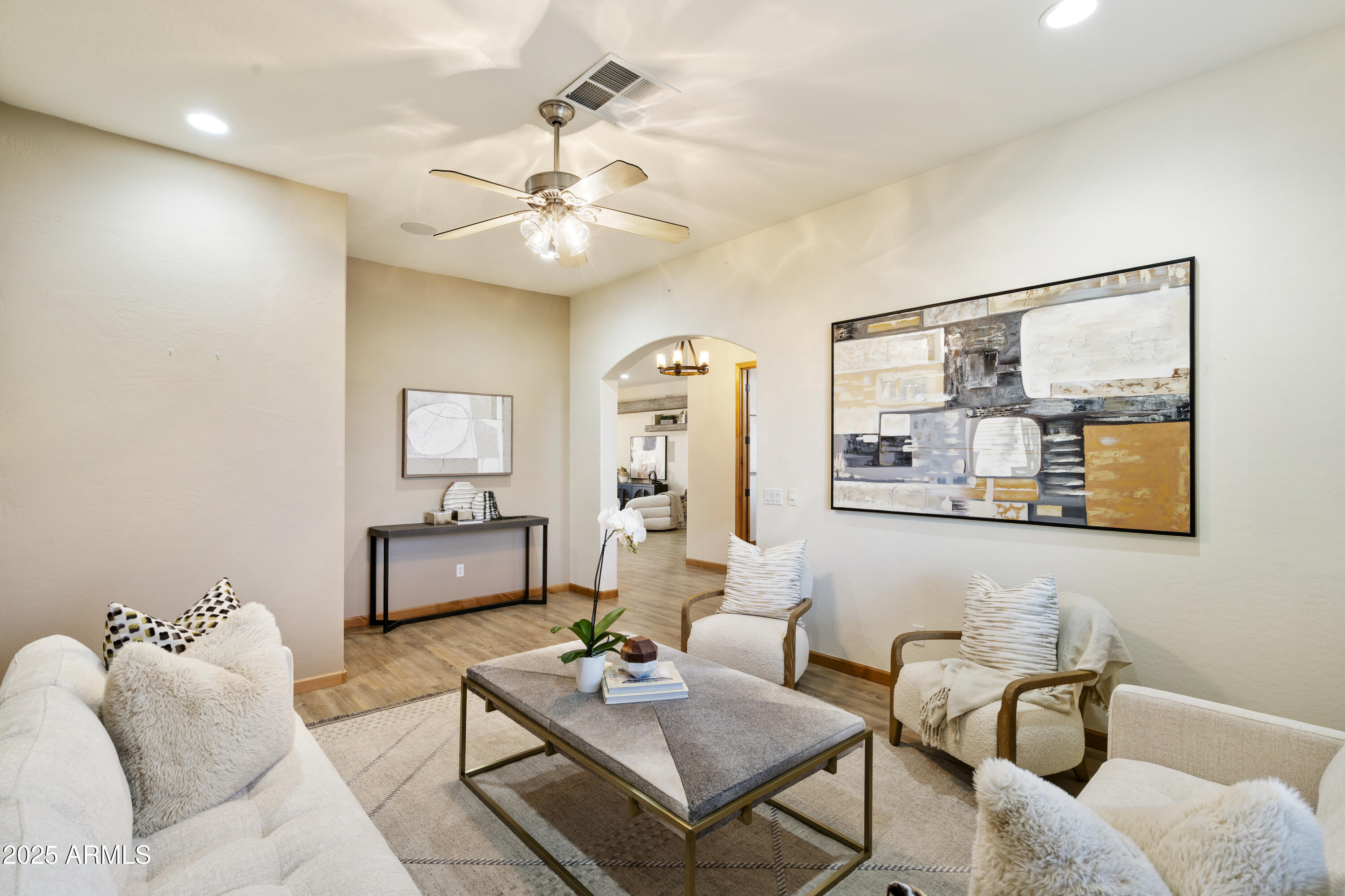 2667 East Melrose Street Gilbert, AZ 85297 - Photo 5 of 32 a living room with furniture and a chandelier