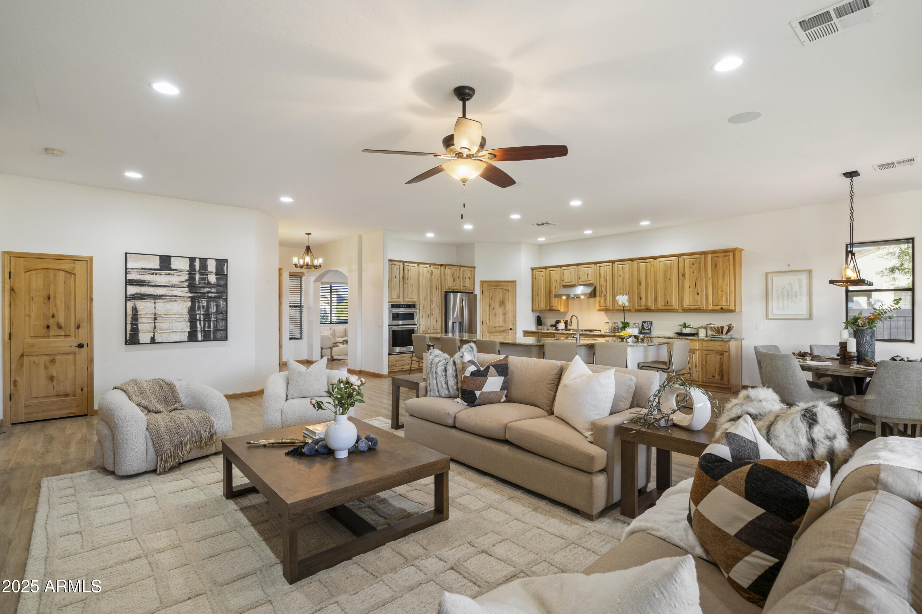 2667 East Melrose Street Gilbert, AZ 85297 - Photo 8 of 32 a living room with furniture kitchen view and a chandelier