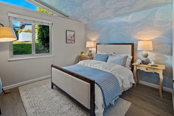 a bedroom with bed and window