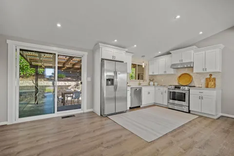 a kitchen with a refrigerator oven and a sink
