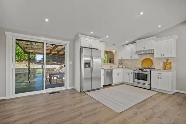a kitchen with a refrigerator oven and a sink