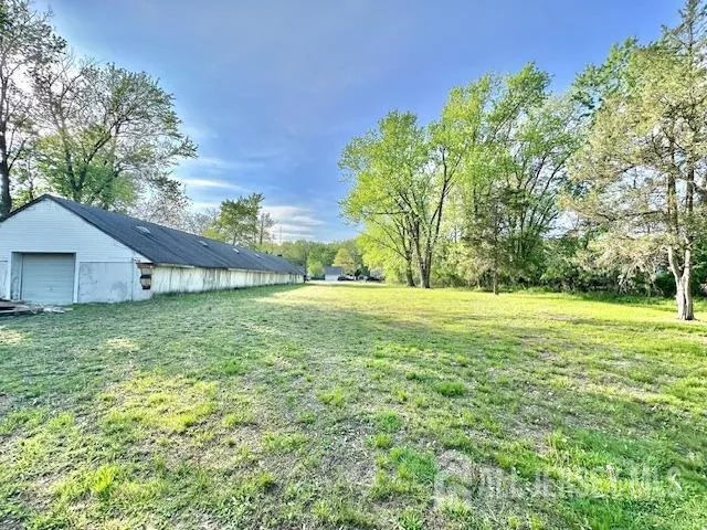 a view of a backyard with large trees
