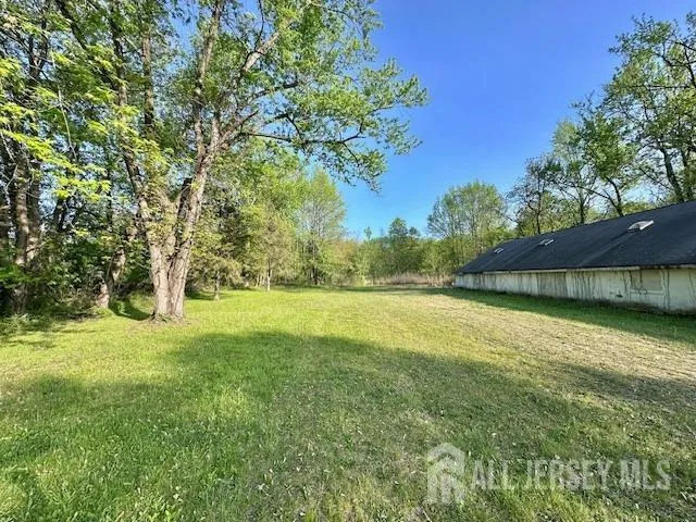 a view of a yard with a house in the background
