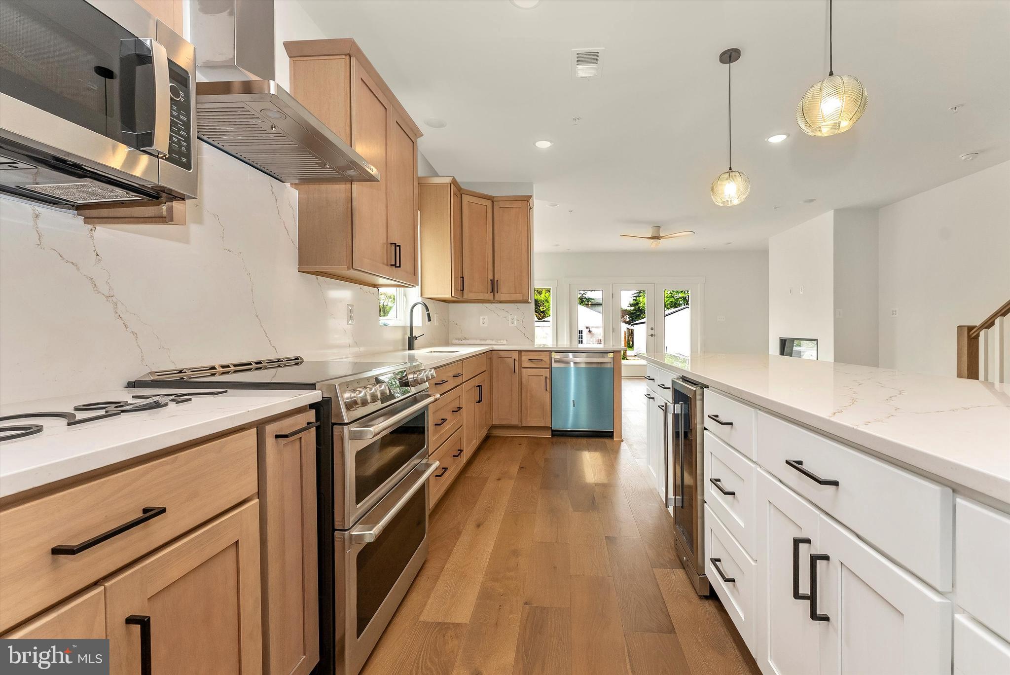 328 Madison Street Frederick, MD 21701 - Photo 13 of 49 a kitchen with stainless steel appliances a stove sink and cabinets