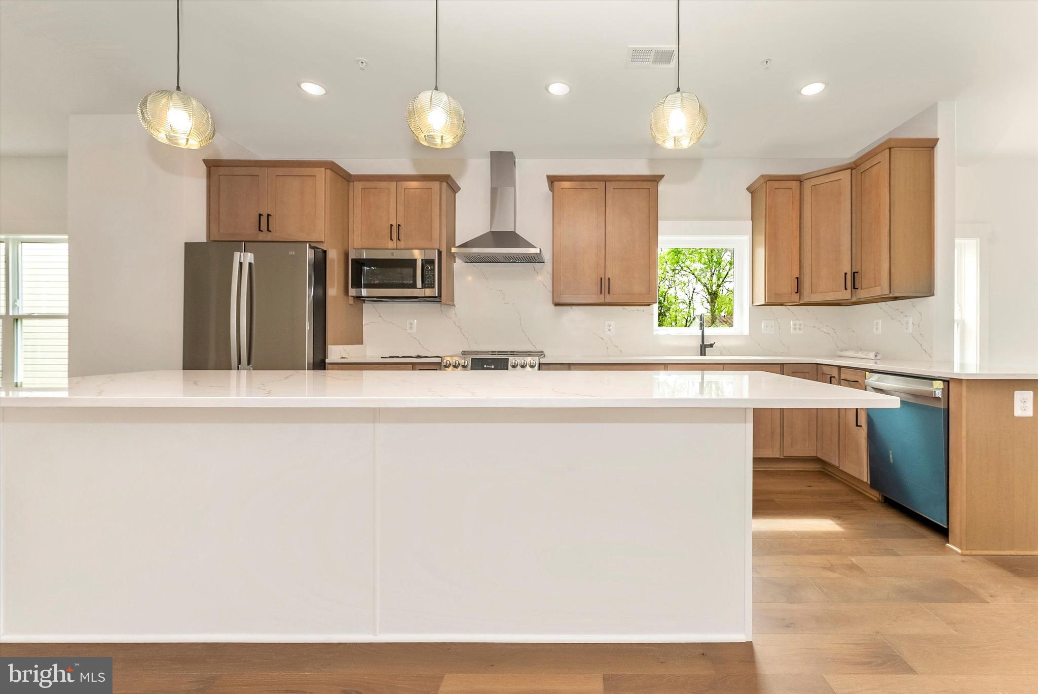 328 Madison Street Frederick, MD 21701 - Photo 14 of 49 a kitchen with kitchen island a counter top space a sink appliances and cabinets