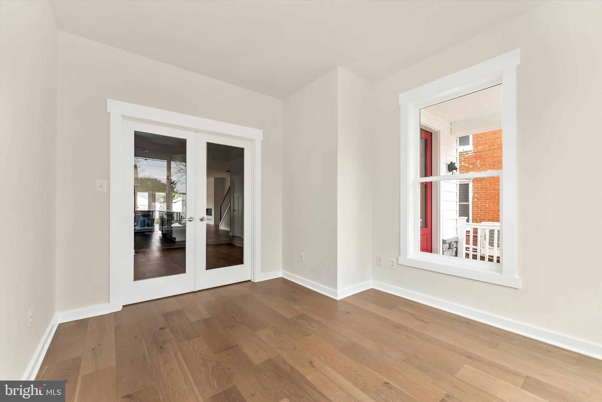 328 Madison Street Frederick, MD 21701 - Photo 20 of 49 an empty room with wooden floor and windows