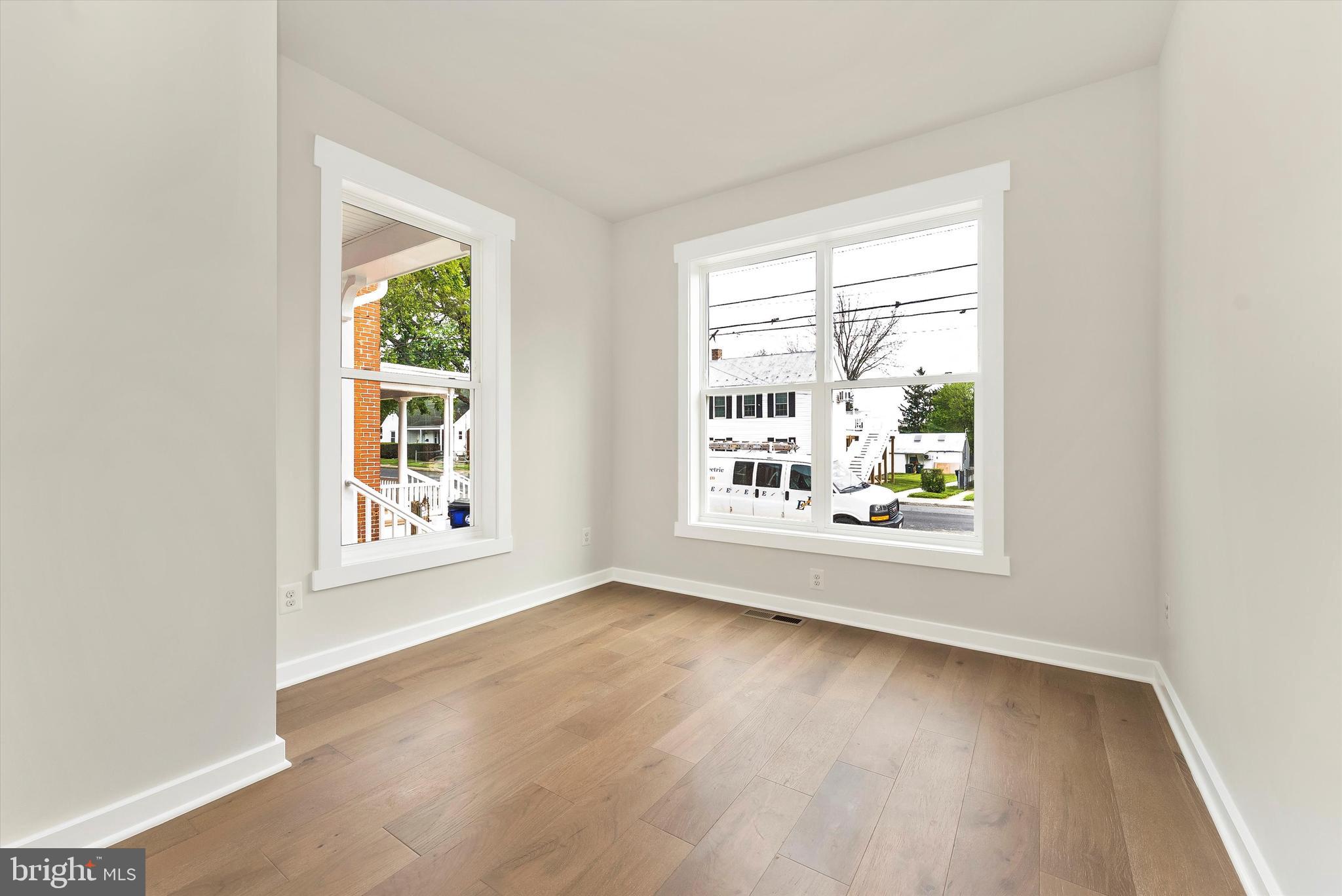 328 Madison Street Frederick, MD 21701 - Photo 22 of 49 an empty room with wooden floor and windows