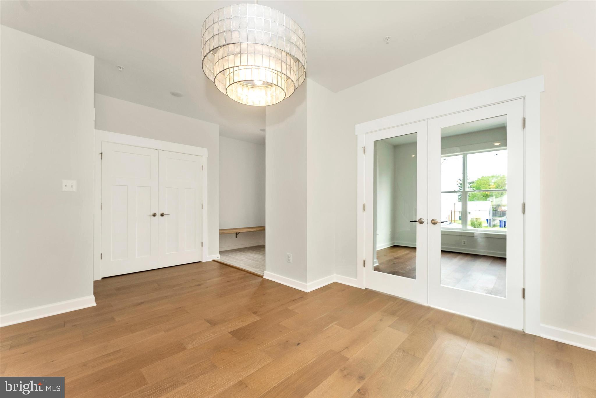 328 Madison Street Frederick, MD 21701 - Photo 24 of 49 a view of a livingroom with wooden floor and a chandelier