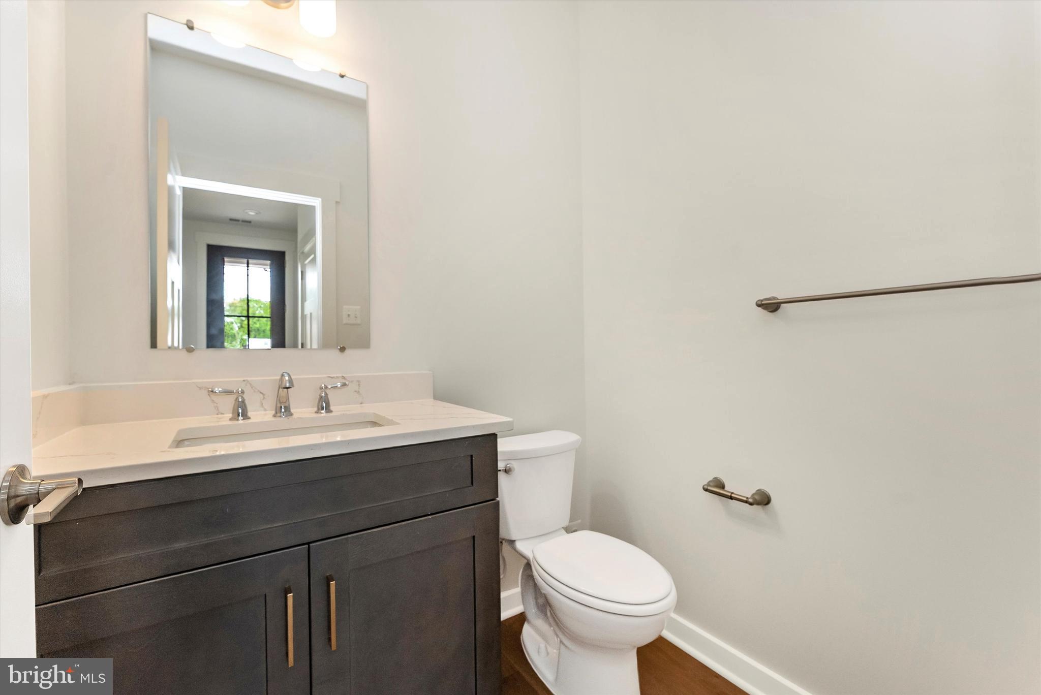 328 Madison Street Frederick, MD 21701 - Photo 25 of 49 a bathroom with a toilet a sink and mirror