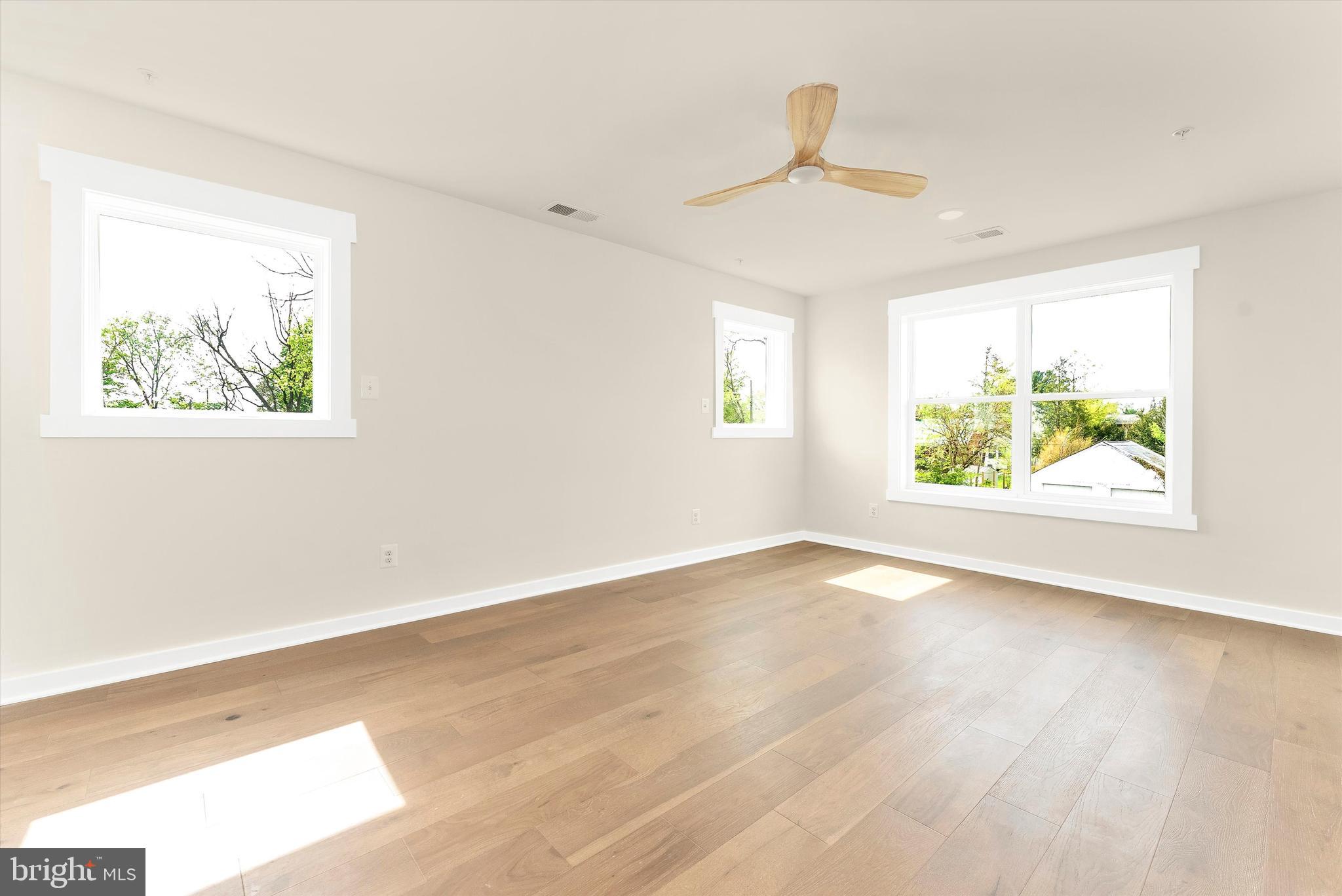 328 Madison Street Frederick, MD 21701 - Photo 26 of 49 wooden floor in an empty room with a window