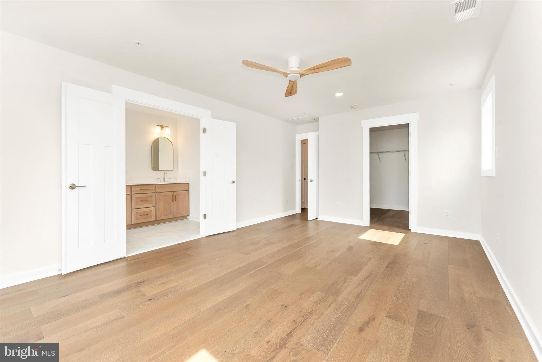 328 Madison Street Frederick, MD 21701 - Photo 27 of 49 an empty room with wooden floor and ceiling fan