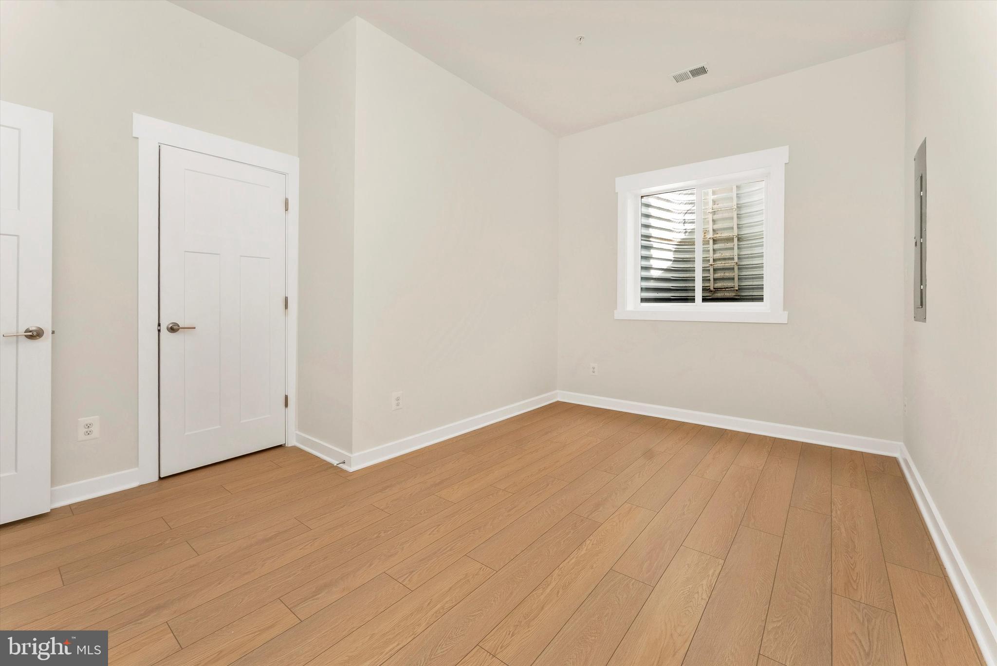 328 Madison Street Frederick, MD 21701 - Photo 40 of 49 an empty room with wooden floor and windows