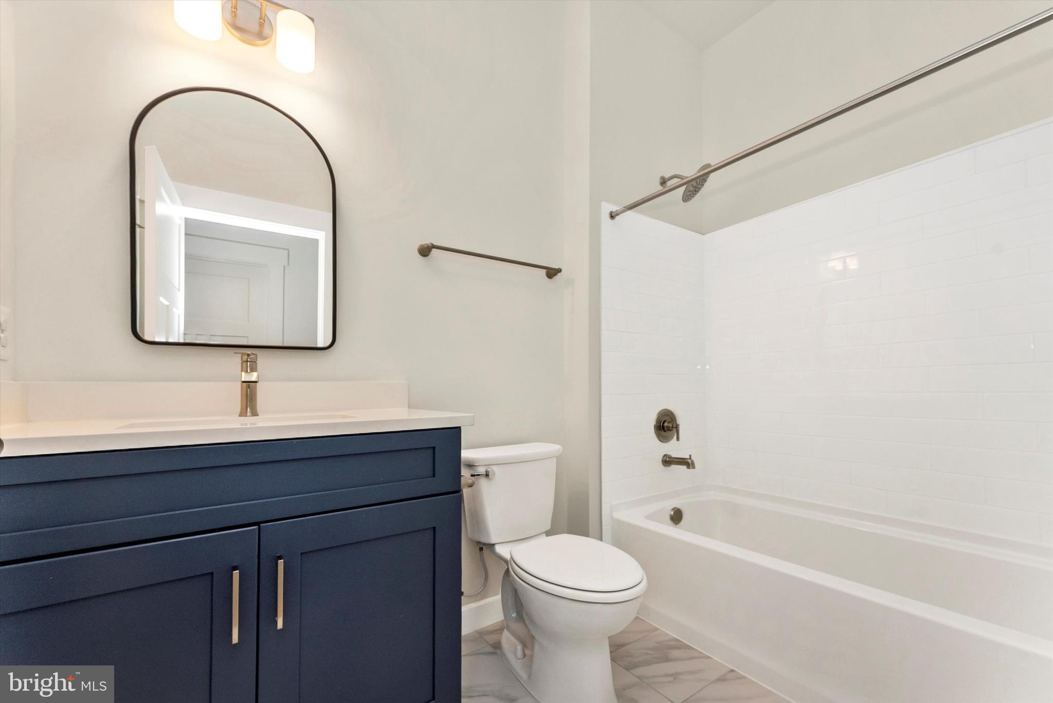 328 Madison Street Frederick, MD 21701 - Photo 41 of 49 a bathroom with a toilet sink and a bathtub