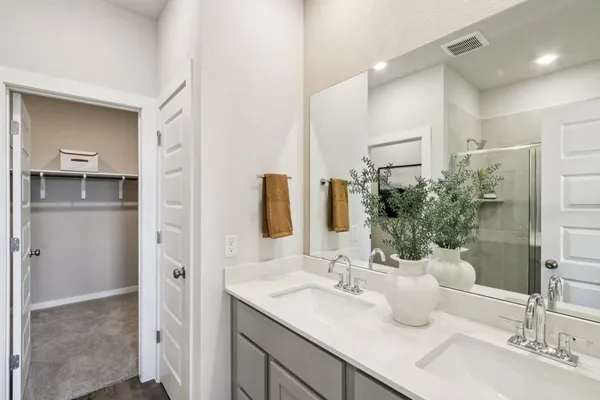 a bedroom with a large bed and a painting on the wall