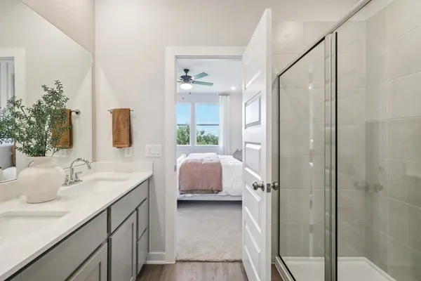 a bedroom with a bed and a mirror on dresser