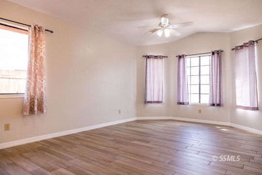 1012 Conejo Avenue Ridgecrest, CA 93555 - Photo 5 of 24 an empty room with wooden floor and windows