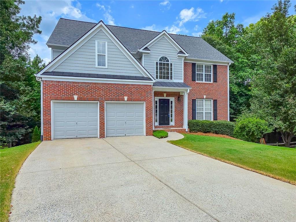 43 Ivy Mist Lane Acworth, GA 30101 - Photo 2 of 58 a front view of a house with a yard and garage