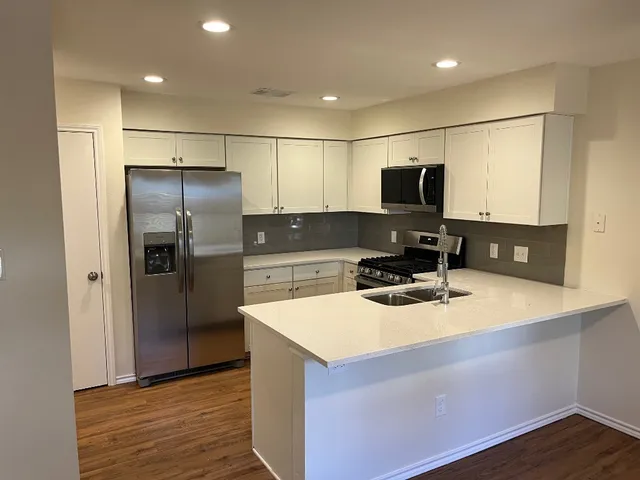 a kitchen with a refrigerator and a sink