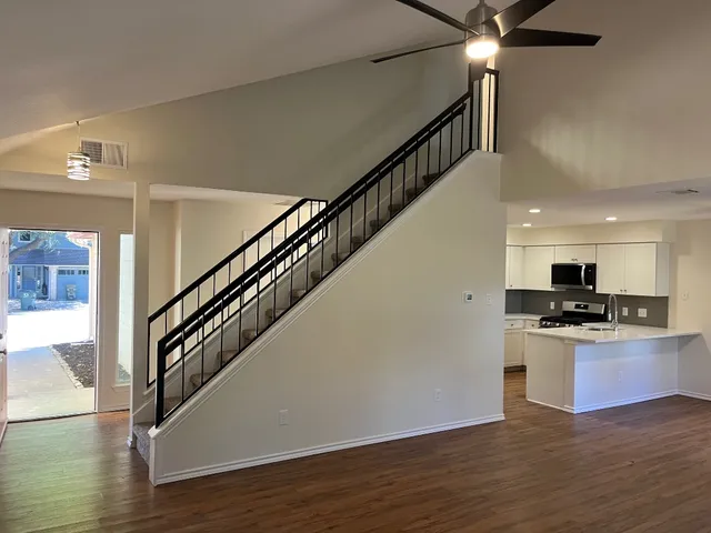 a view of a kitchen with a sink and a stove top oven