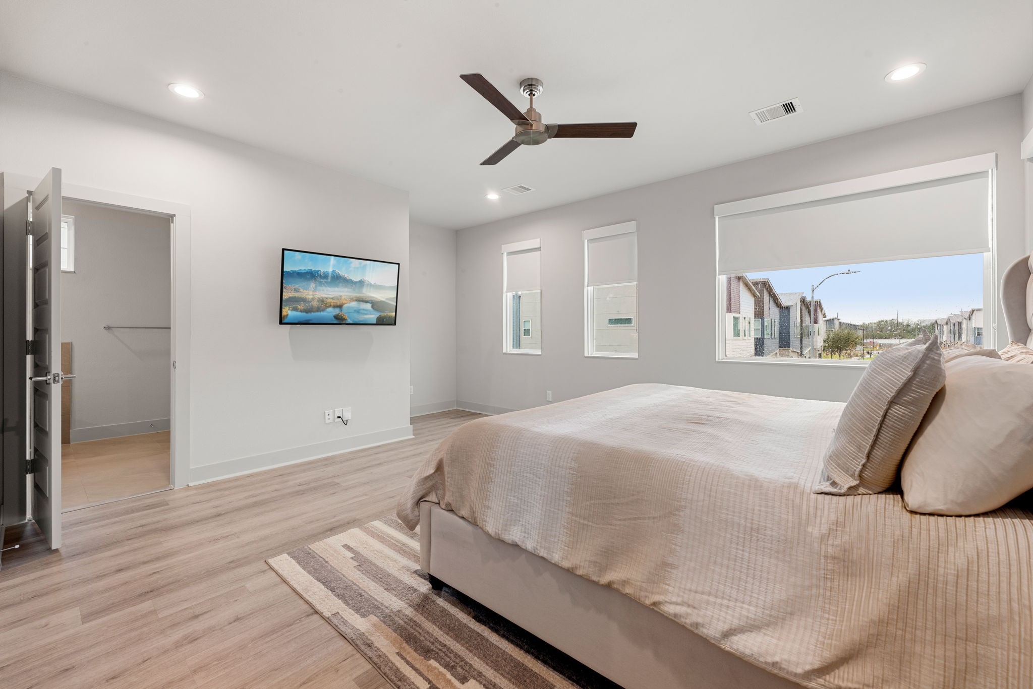5722 Rucio Lane, Unit A Houston, TX 77092 - Photo 13 of 29 Spacious primary bedroom with ceiling fan and natural light.