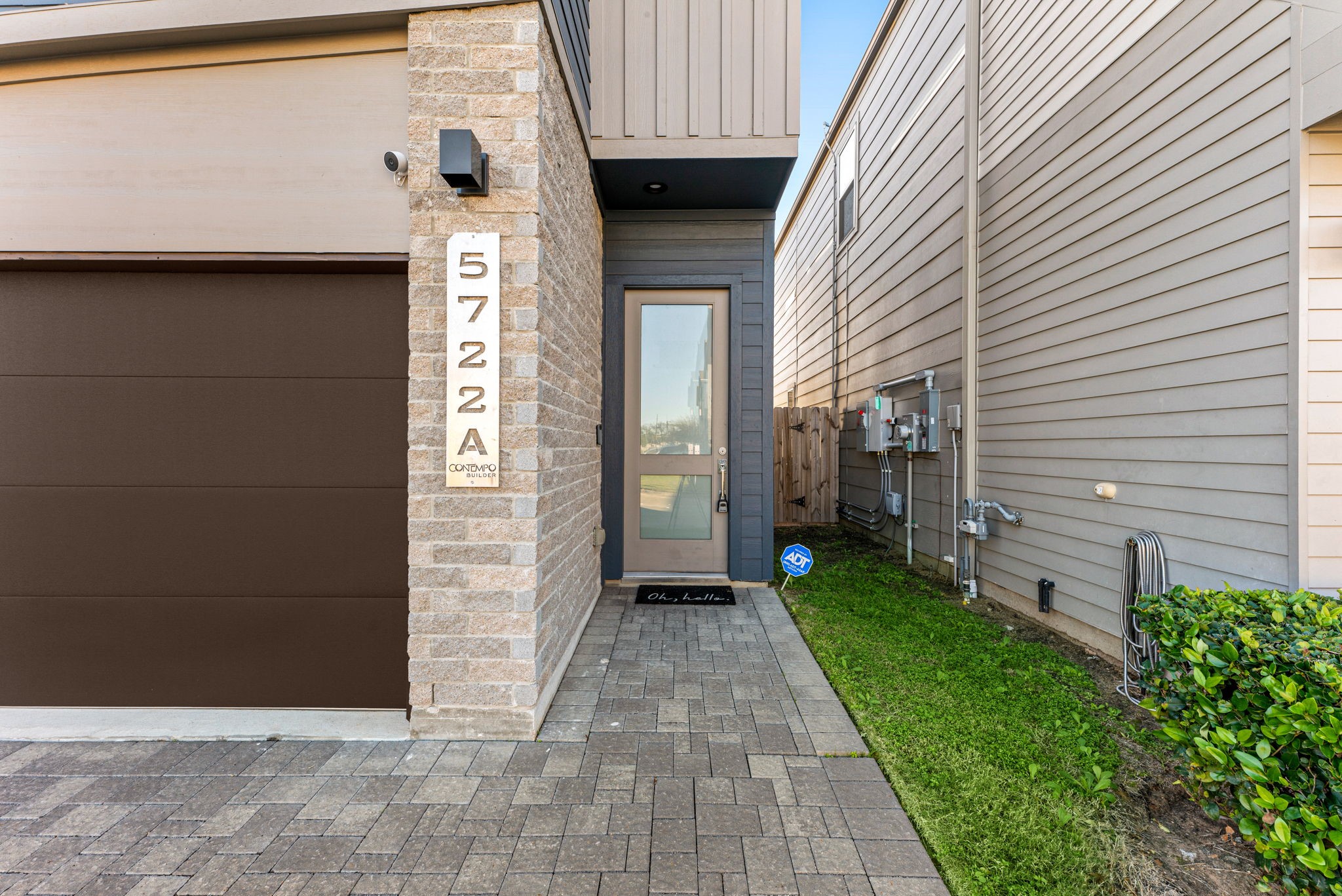 5722 Rucio Lane, Unit A Houston, TX 77092 - Photo 2 of 29 Modern front entry with stone accent, private walkway, and contemporary glass door.