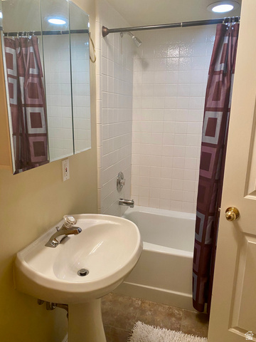 3918 Mapleleaf Way West Jordan, UT 84088 - Photo 10 of 12 Bathroom featuring shower / bath combo with shower curtain and a sink