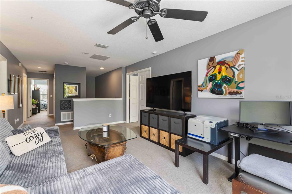 3907 62nd Terrace East Bradenton, FL 34203 - Photo 25 of 63 a living room with furniture and a flat screen tv
