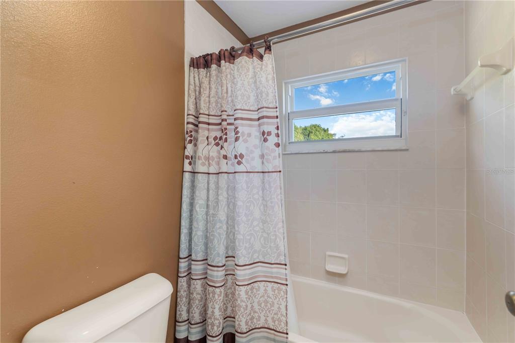3907 62nd Terrace East Bradenton, FL 34203 - Photo 35 of 63 a bathroom with a shower a toilet and bathtub