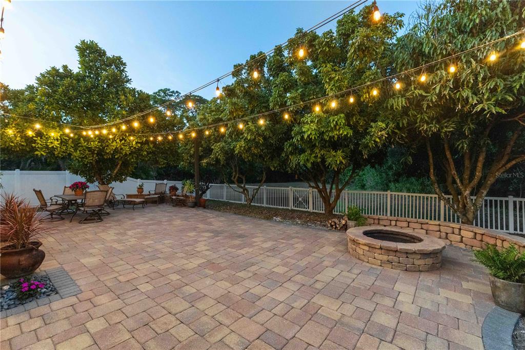 3907 62nd Terrace East Bradenton, FL 34203 - Photo 45 of 63 a view of a backyard with table and chairs and a fire pit