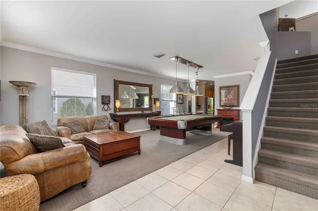 a kitchen with stainless steel appliances granite countertop a sink a stove a refrigerator white cabinets and wooden floor