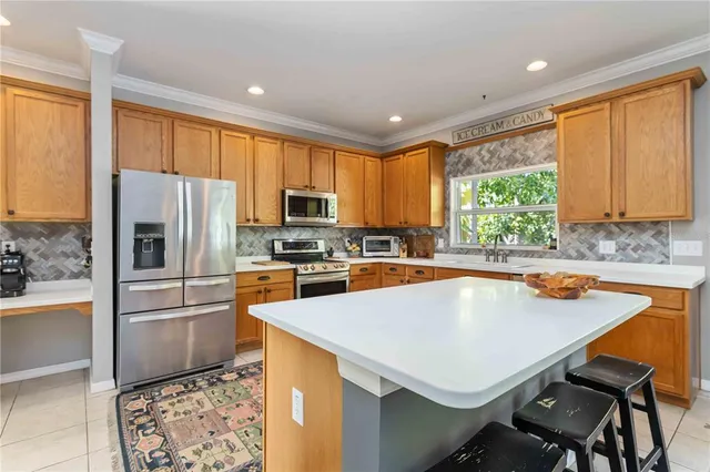 a living room with furniture a flat screen tv and a floor to ceiling window