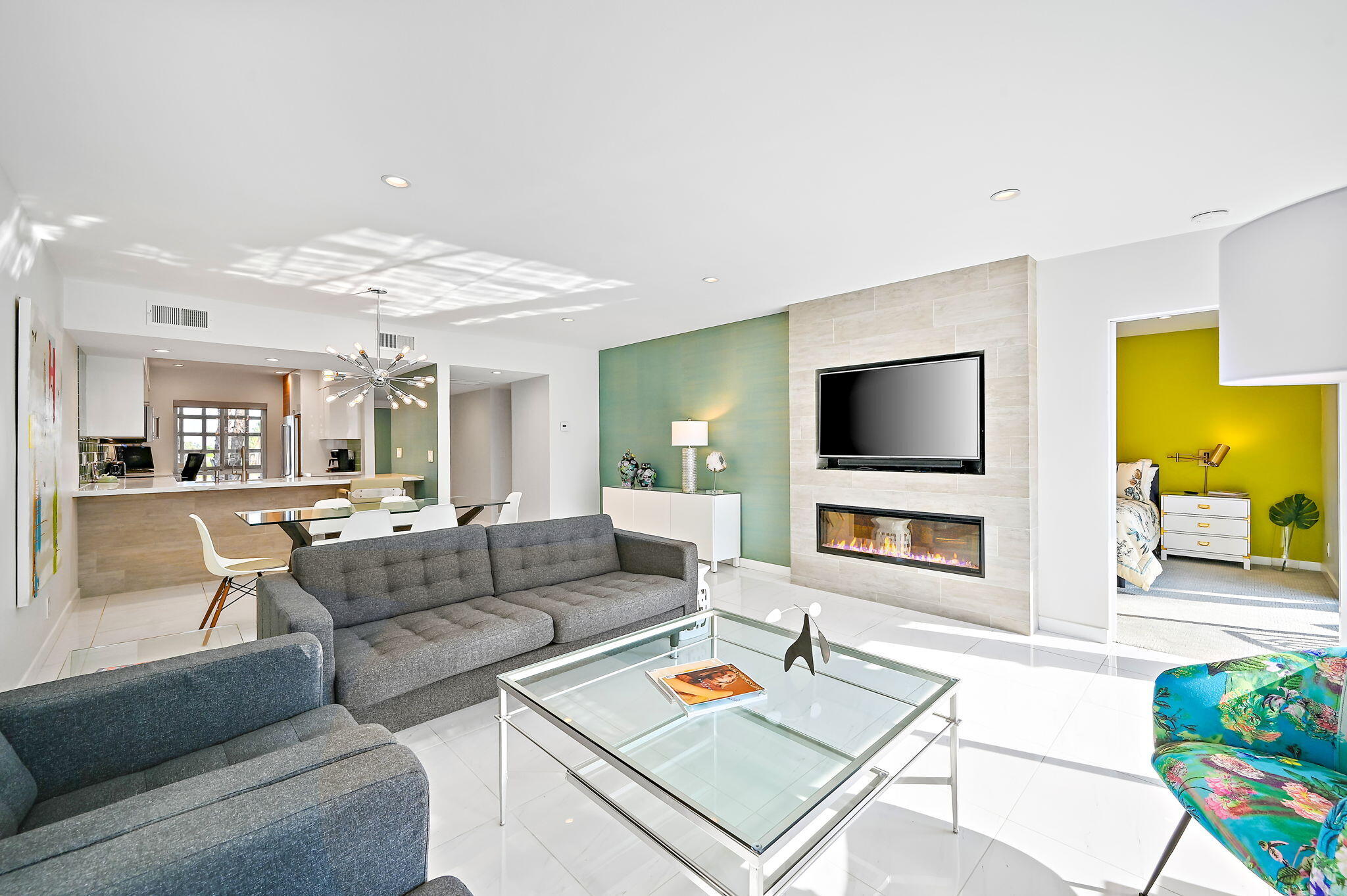 277 East Alejo Road, Unit 215 Palm Springs, CA 92262 - Photo 13 of 52 a living room with furniture and a flat screen tv