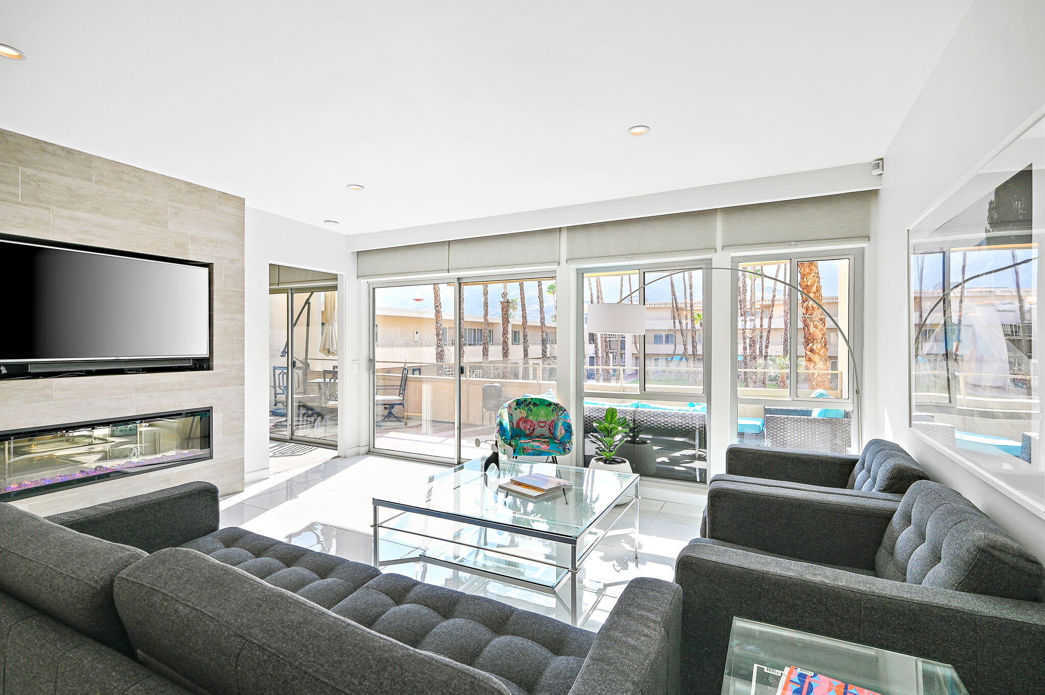 277 East Alejo Road, Unit 215 Palm Springs, CA 92262 - Photo 14 of 52 a living room with furniture and a flat screen tv