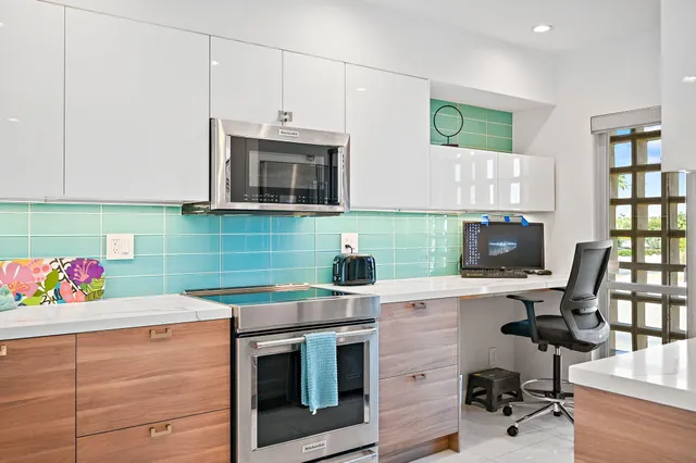 a kitchen with kitchen island a sink stainless steel appliances and cabinets