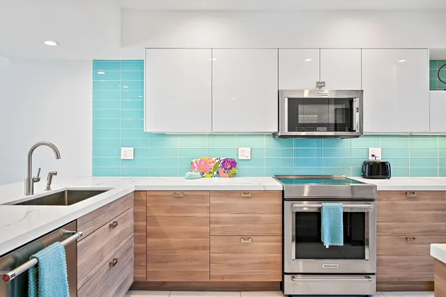 a kitchen with stainless steel appliances a sink counter top and stainless steel appliances