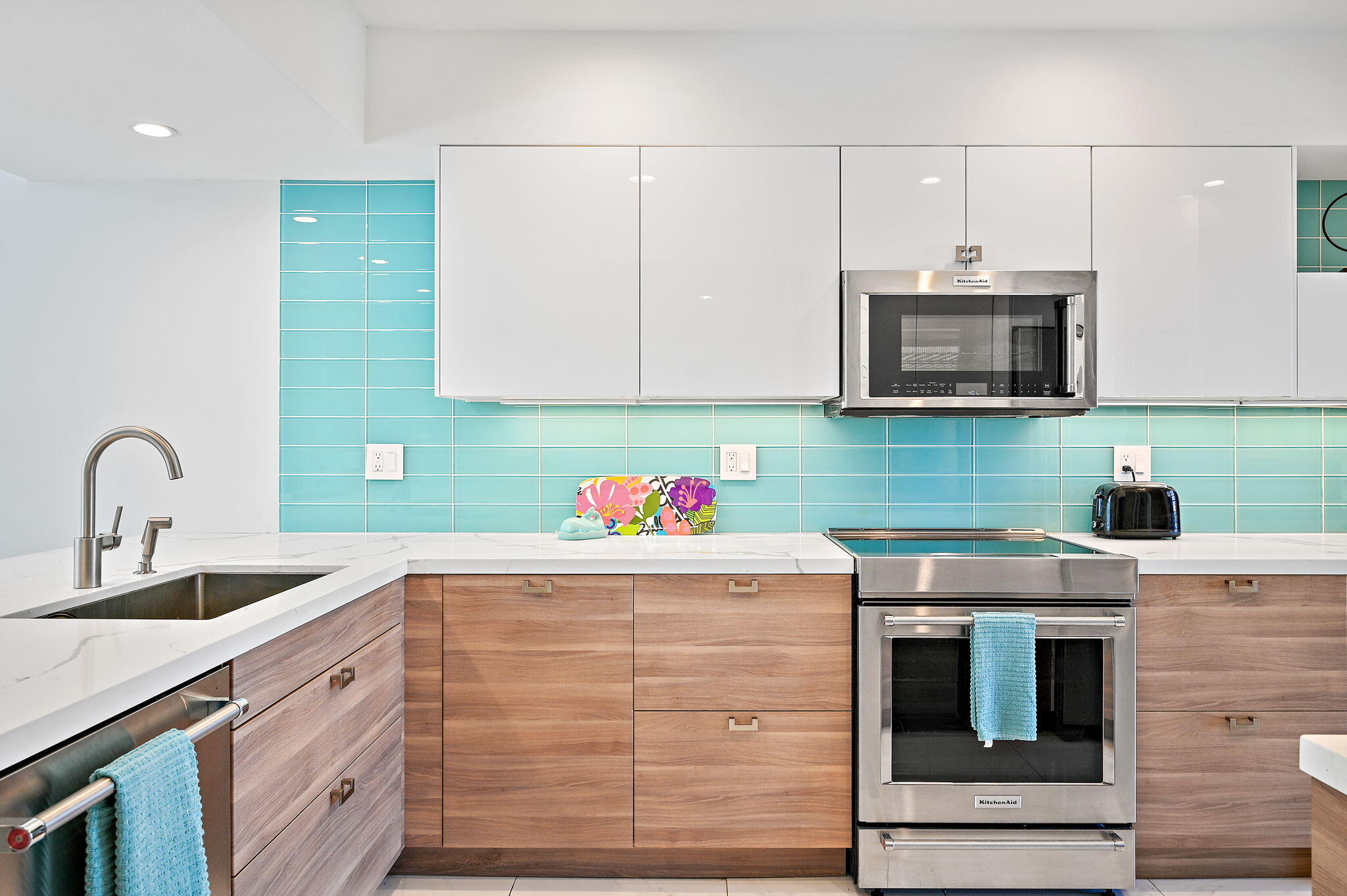 277 East Alejo Road, Unit 215 Palm Springs, CA 92262 - Photo 22 of 52 a kitchen with kitchen island a sink stainless steel appliances and cabinets